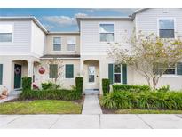 Townhouse exterior with landscaping, walkway, and inviting entrance at 269 Primrose Dr, Davenport, FL 33837