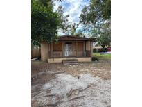 Fixer-upper house with boarded windows and a covered porch at 3108 Lawrence St, Orlando, FL 32805
