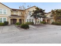 Charming townhome with a red tile roof, arched entryway and well-maintained landscaping at 4775 Terrasonesta Dr, Davenport, FL 33837