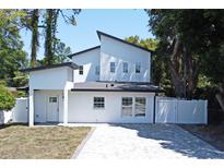 Contemporary two-story home with a black roof and white stucco exterior at 5255 Seminole Ave, Winter Park, FL 32792