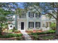 Charming two-story home with a covered porch and nicely landscaped front yard at 3929 Corrine Dr, Orlando, FL 32814