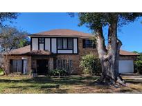 Charming two-story brick home featuring a well-manicured lawn and a classic architectural style at 9130 Dollanger Ct, Orlando, FL 32819