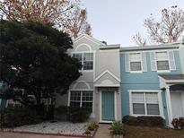 Two-story townhome with teal accents and landscaping at 922 Vineland Pl, Lake Mary, FL 32746