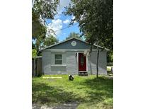 Charming brick home with a red door and well-manicured lawn at 1320 S Oleander Ave, Sanford, FL 32771