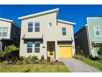 Modern two-story home with yellow garage door and landscaped front yard at 2763 Oxymoron Way, Kissimmee, FL 34746