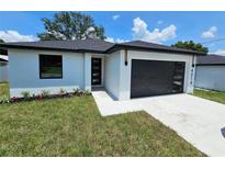 Charming single-story home featuring modern design elements and well-manicured lawn at 0 Robinson Dr, Haines City, FL 33844
