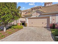 Exterior view of a two-story townhome with a two-car garage and manicured landscaping at 1348 Gilford Point Ln, Davenport, FL 33896