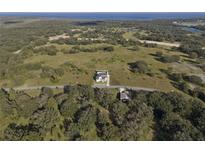 An aerial view of the property showing the house, land, nearby trees, and the neighborhood at 3705 Ridge Run Dr, Minneola, FL 34715
