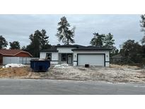 Newly constructed home with a modern design and two-car garage at 4020 Sw 151 Pl, Ocala, FL 34473