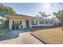 Brick ranch home with a spacious yard and driveway at 4213 Seybold Ave, Orlando, FL 32808