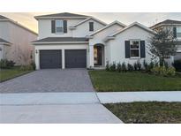 Two-story house with a two-car garage and manicured lawn at 4421 Lions Gate Ave, Clermont, FL 34711