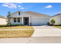 Charming single-story home with manicured lawn, paver driveway, and two-car garage at 142 Jones Fish Camp Rd, Edgewater, FL 32141