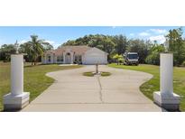 Beautiful single-story home featuring a circular driveway, manicured lawn, and RV parking at 3871 Dallas Blvd, Orlando, FL 32833
