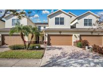 Two-story townhome with attached garage and landscaped front yard at 564 Woodland Terrace Blvd, Orlando, FL 32828