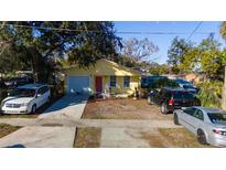 Updated yellow house with a driveway and landscaping at 1235 19Th St, Orlando, FL 32805