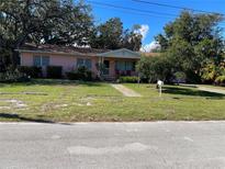 Pink single story house with well-maintained lawn at 1520 Moravia Ave, Holly Hill, FL 32117