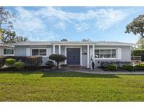 Gray house with blue door, landscaped yard, and walkway at 604 Endsley Ave, Altamonte Springs, FL 32701