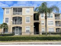 Condo building exterior with balconies and landscaping at 8103 Coconut Palm Way # 105, Kissimmee, FL 34747