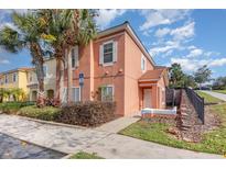 Attractive two-story townhome with landscaping, sidewalk, and gated community at 3152 Yellow Lantana Ln, Kissimmee, FL 34747