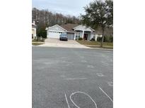 Two-story house with a two car garage and a spacious front yard at 3603 Kariba Ct, Kissimmee, FL 34746