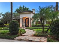 Elegant home with stone pathway, lush landscaping, and a captivating entryway at 1426 Nottingham St, Orlando, FL 32803