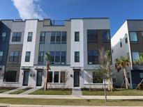 Modern three-story townhome with gray and white exterior at 2026 Packing District Way, Orlando, FL 32804