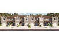Three-unit townhome building with attached garages and neutral color palette at 2199 Longleaf Rd, Davenport, FL 33837