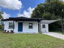Newly renovated home with a carport and landscaped lawn at 2340 Hamilton St, Bartow, FL 33830