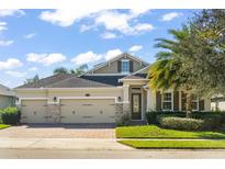 Two-story house with three-car garage and landscaping at 31921 Redtail Reserve Blvd, Sorrento, FL 32776
