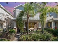 Two-story house with stone and shingle accents, landscaping, and walkway at 5539 Bowman Dr, Winter Garden, FL 34787