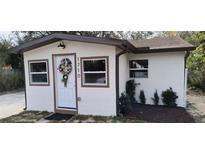 Charming single story home with white exterior and landscaping at 1710 E Bay St, Winter Garden, FL 34787