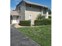 Tan two-story house with white door and well-manicured lawn at 1902 Abbington St # 1902, Apopka, FL 32712