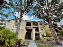 Two-story condo building with trees and landscaping at 2652 Robert Trend Jones # 533, Orlando, FL 32835