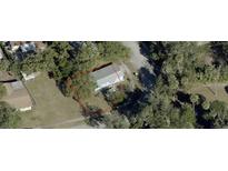 Aerial view showing a single-Gathering home on a tree-lined lot at 121 Valencia Dr, Edgewater, FL 32132