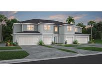 Three-unit townhome building with two-car garages and landscaped yards at 2502 Winsome Way, Davenport, FL 33896