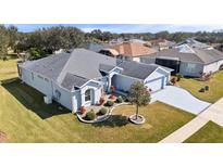 Well-maintained home featuring a neatly manicured lawn and a freshly painted exterior at 26812 Augusta Springs Cir, Leesburg, FL 34748