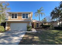 Two-story house with attached garage and landscaped lawn at 2809 Strand Loop Ct, Oviedo, FL 32765