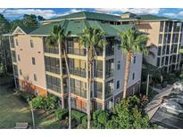 Attractive condo building with palm trees and ample parking at 9051 Treasure Trove Ln # 301, Kissimmee, FL 34747