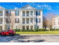 Three-story condo building with traditional architecture and balconies at 231 Goldenrain Dr # 4304, Celebration, FL 34747