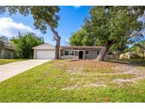 Ranch style home with mature trees and a large yard at 332 Hidden Lake Dr, Sanford, FL 32773