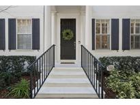 White exterior with black shutters and a dark-colored door at 1641 Lake Baldwin Ln, Orlando, FL 32814