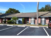 Brick condo with blue siding, landscaping, and parking at 2912 Squire Oak Ct, St Cloud, FL 34769