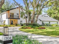 Modern two-story home with landscaped yard and driveway at 304 E Greentree Ln, Lake Mary, FL 32746