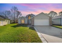 Two-story house with a large yard and attached garage at 3846 Long Grove Ln, Port Orange, FL 32129