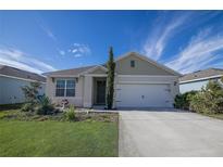 One-story home with a two-car garage and landscaped lawn at 613 Greymount St, Davenport, FL 33837
