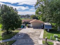 Single-story home with a large yard and driveway, offering curb appeal at 108 Nicole Ln, Longwood, FL 32750