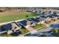 Beautiful single Gathering home with manicured lawn and brick paved driveway at 2249 Palmetum Loop, Apopka, FL 32712