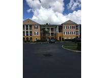 Building exterior featuring a two-story building with columns and parking at 3757 Conroy Rd # 2525, Orlando, FL 32839