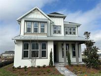 Beautiful two-story home featuring a modern farmhouse facade, landscaped yard and inviting walkway at 9819 Gobat Aly, Orlando, FL 32827