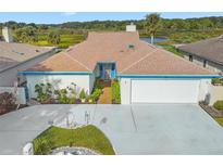 Attractive single-story home with a landscaped yard and two-car garage at 1433 Lake Marion Dr, Apopka, FL 32712